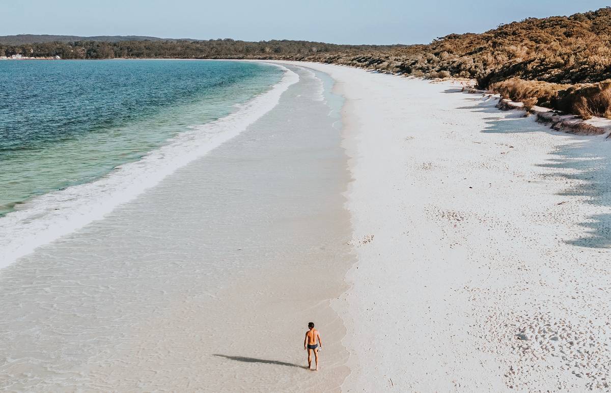 Aerial view of Hyams Beach with clear blue water and pristine white sand