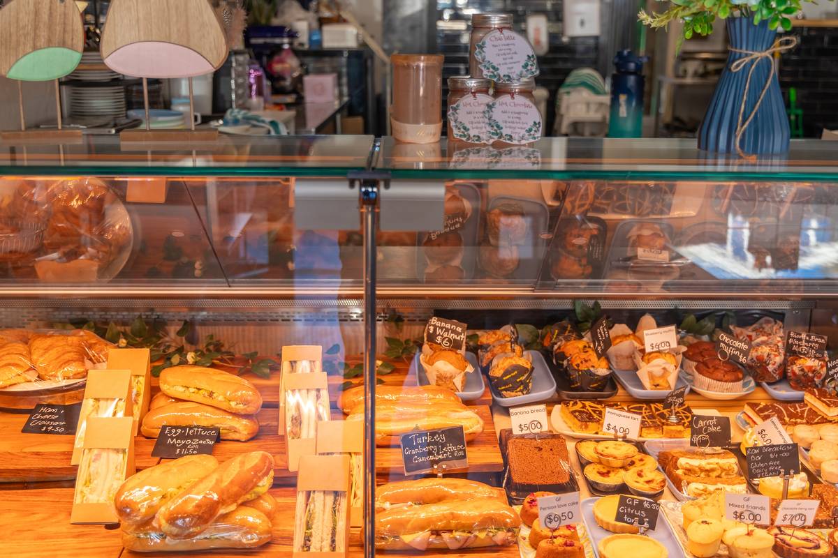 Bakery display case filled with freshly made pastries, sandwiches, and treats in Bowral