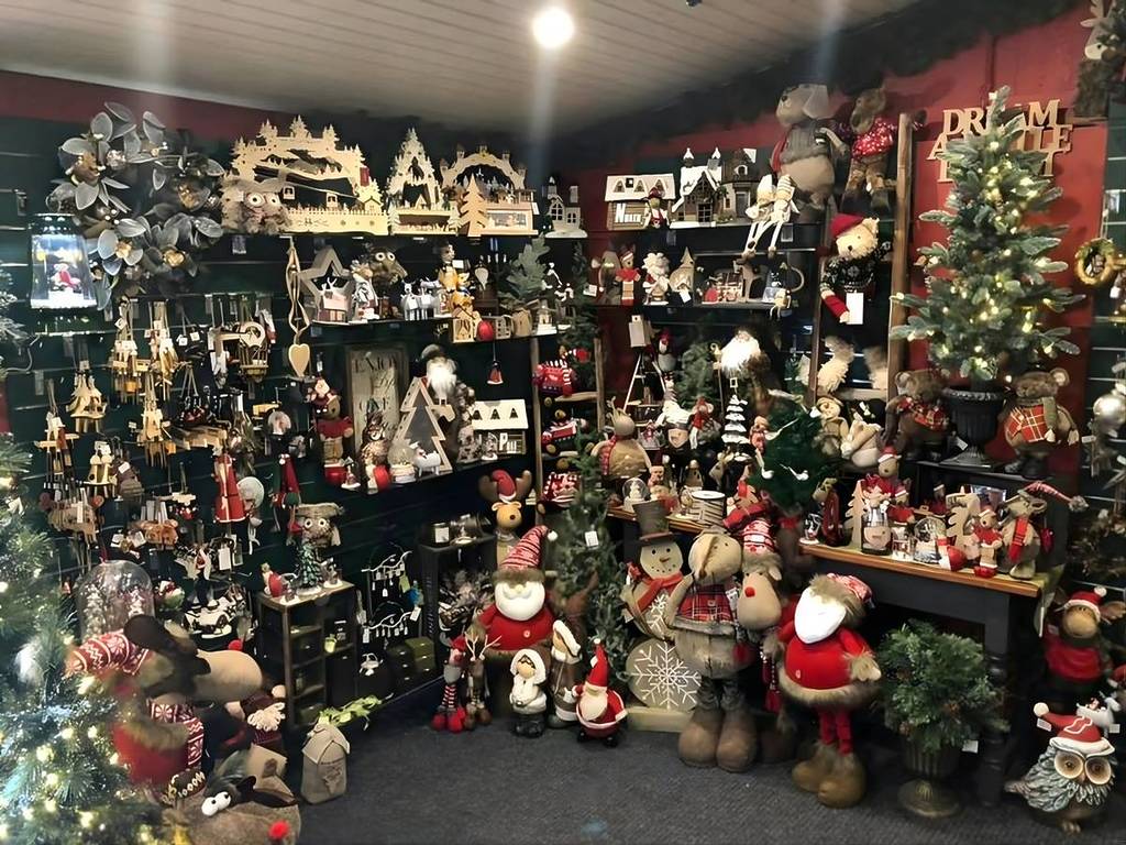 Densely packed interior display of Christmas ornaments and plush toys at Christmas Lane, Morpeth