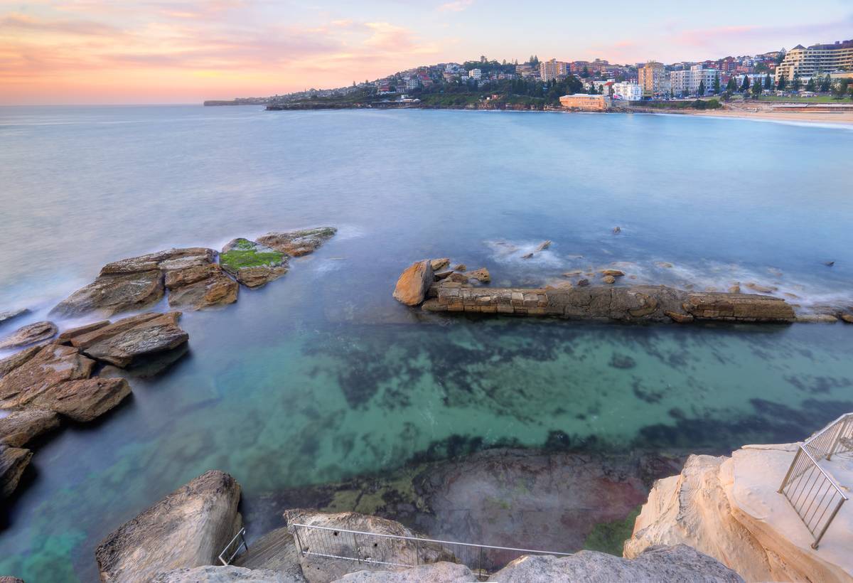 Turquoise water in the natural rock pool at Giles Baths, Coogee, with the open ocean in the background