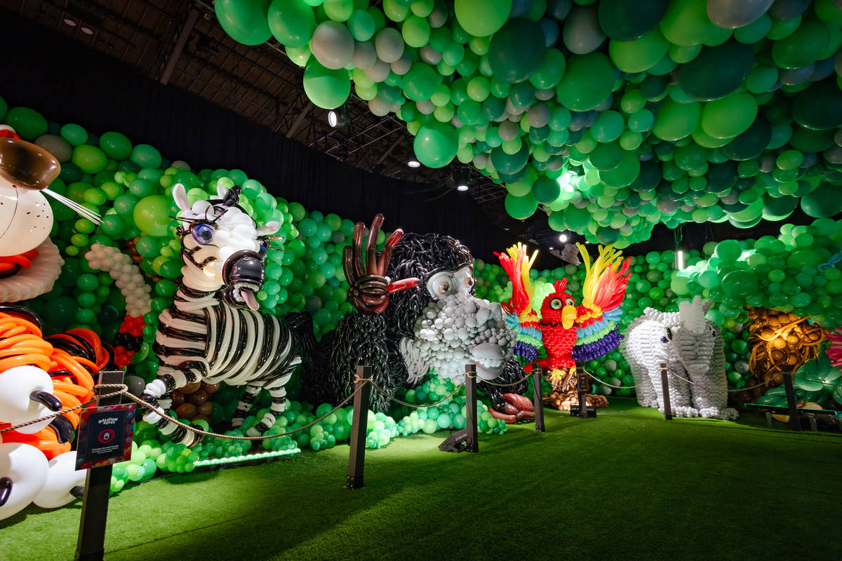 A lion, zebra, monkey, bird and elephant stand in a row, created entirely by balloons for Balloon Story.