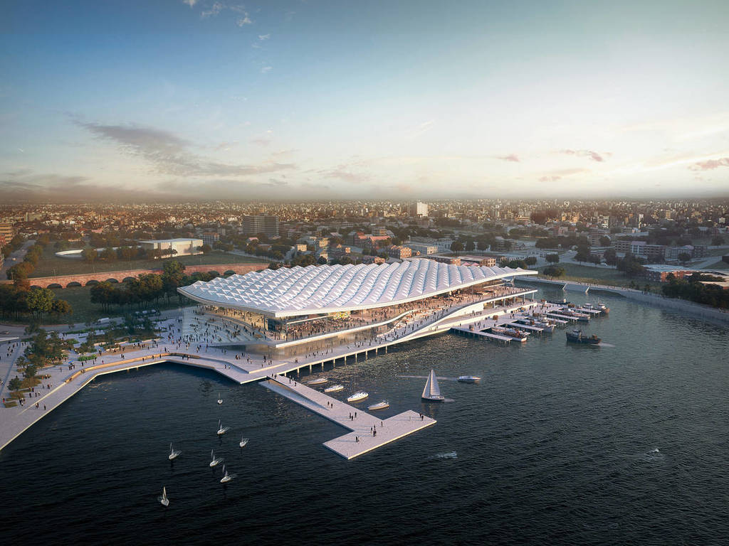 An aerial view of the new Sydney Fish Market on Blackwattle Bay, showing the waterfront building, boats and surrounding harbour