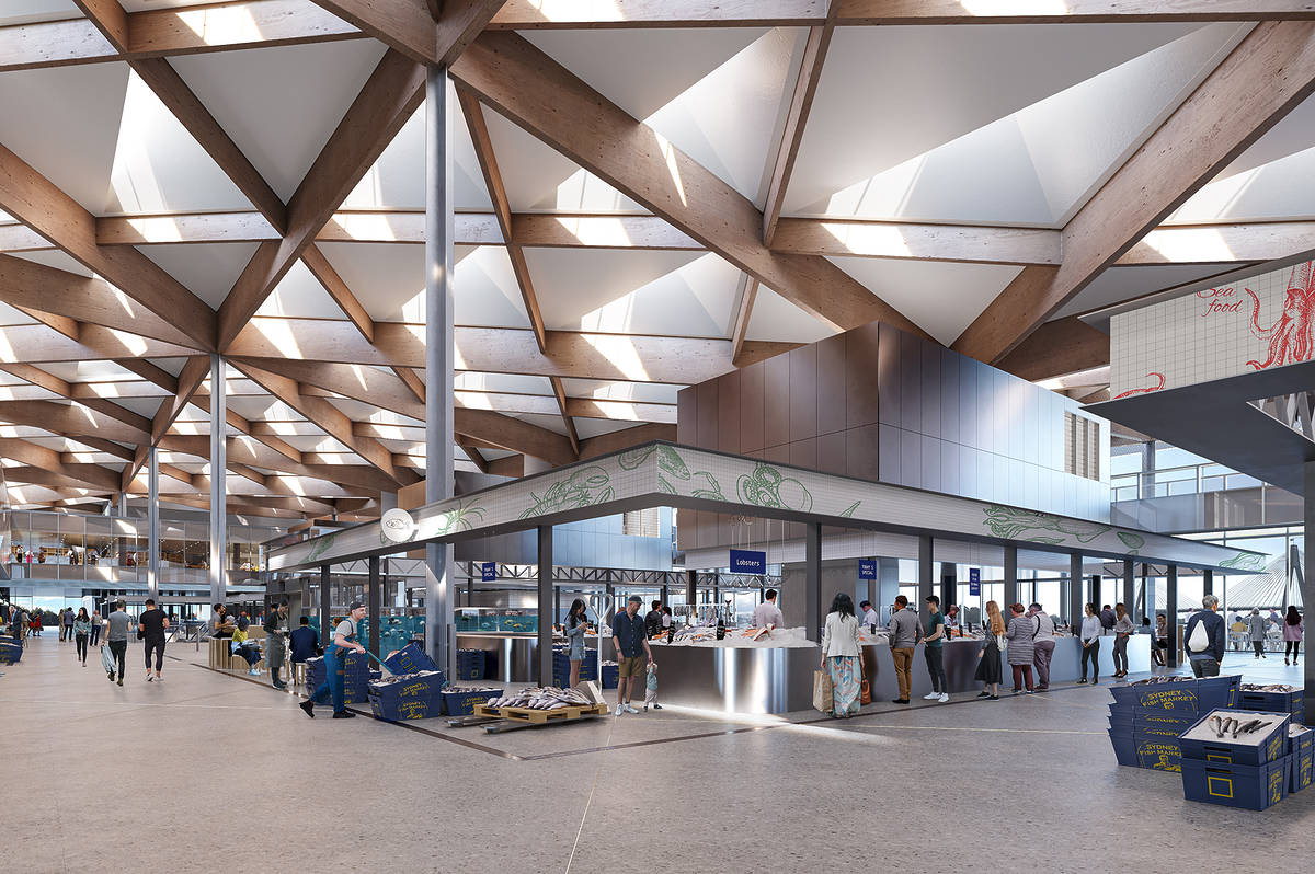 Inside the new Sydney Fish Market, showing seafood stalls, shoppers and the timber roof structure above the trading floor