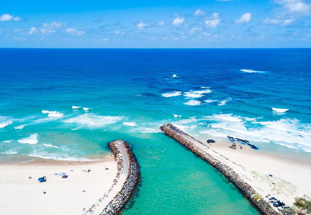 Kingscliff and Cudgen Creek from an aerial view with blue water on a clear day in NSW, Australia