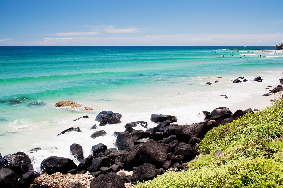 Rocky shoreline and turquoise water along the Kingscliff coastline on a sunny day