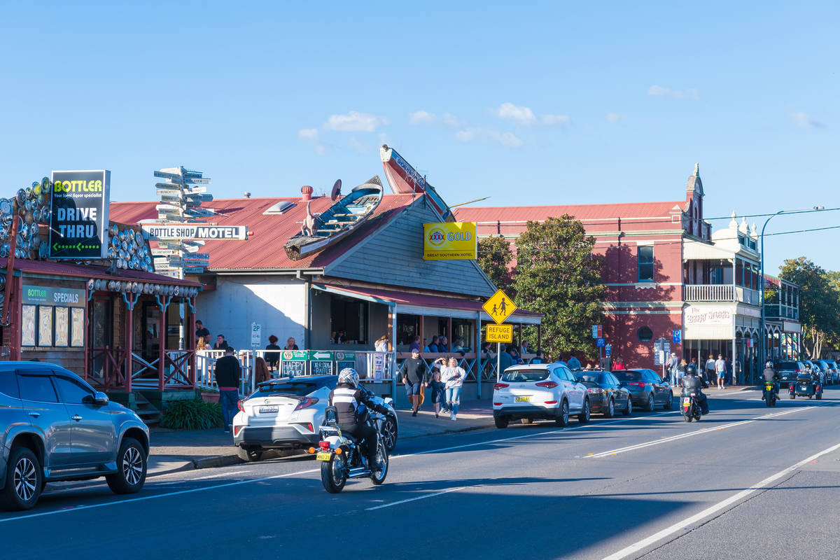 People strolling past cafes, pubs and heritage buildings along the main street in Berry, NSW, on a sunny afternoon