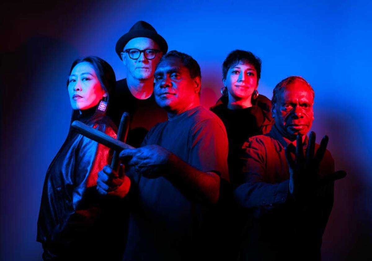 Hand to earth band pictured in neon lights