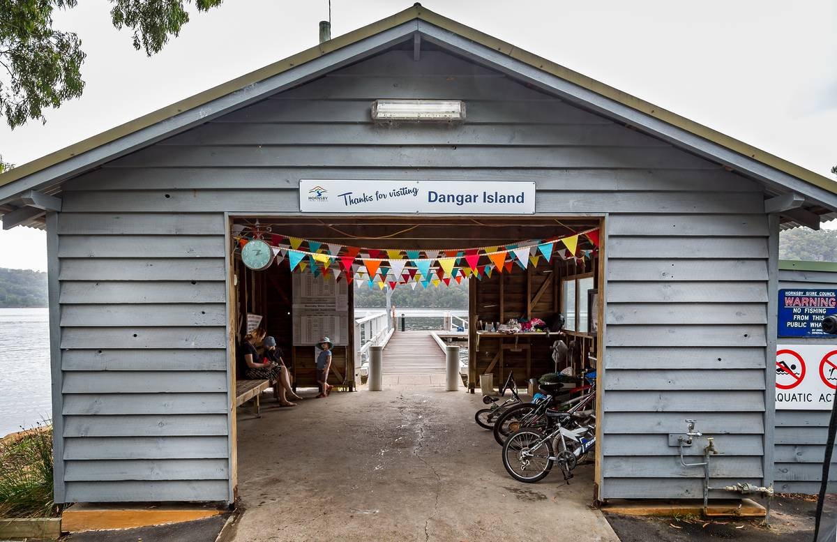 Dangar Island ferry wharf entrance with bunting and bikes near the Hawkesbury River