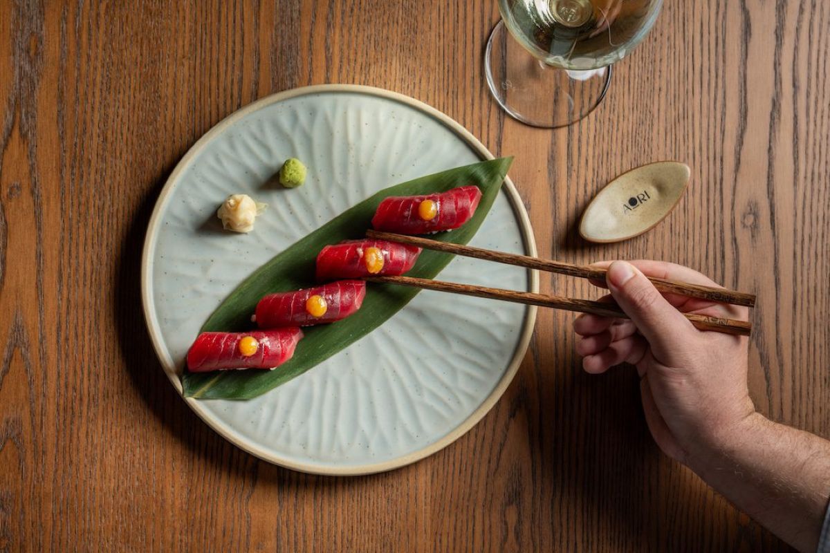 chopsticks picking up sushi at Aori