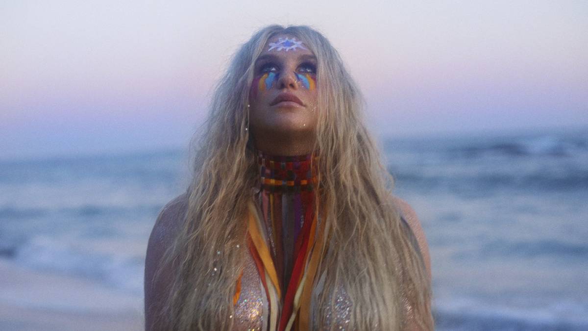 Kesha standing at the beach, looking ethereal