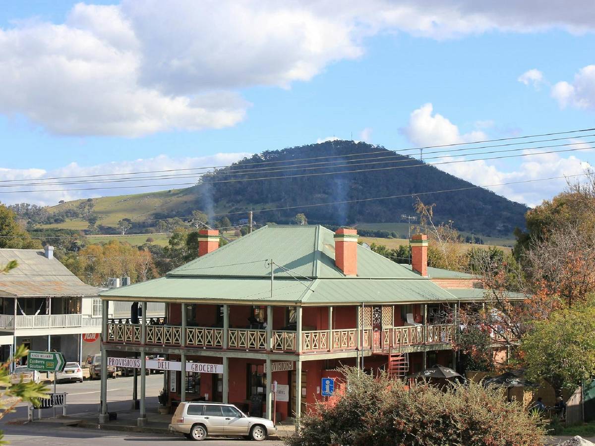 Heritage buildings in Braidwood with rolling countryside and a hill backdrop in the Southern Tablelands, NSW