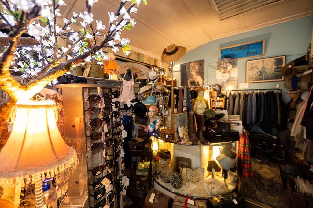 Interior of a vintage shop filled with antique clothing, hats, sunglasses and collectibles at Victory Theatre Antique Centre in Blackheath