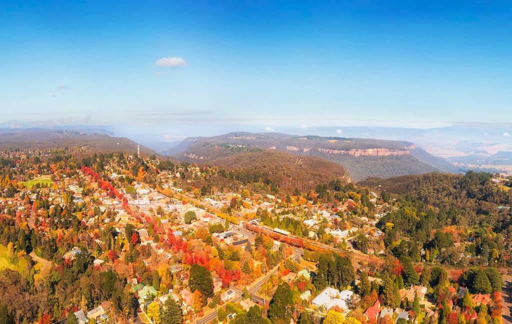 Aerial view of Blackheath in the Blue Mountains surrounded by colourful autumn foliage and mountain views