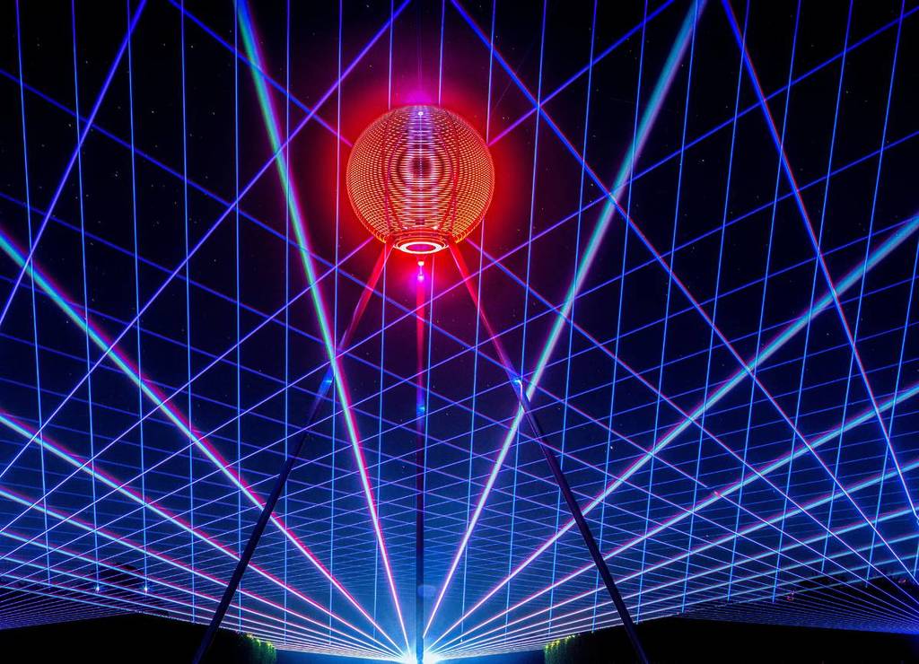 Large laser light installation forming a glowing grid and sphere during Vivid Sydney's Molecule of Light installation at Barangaroo Reserve