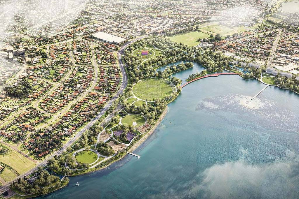 Aerial rendering of a large lakeside park with open green spaces, walking trails, sports fields and surrounding suburban neighbourhood near Lake Illawarra