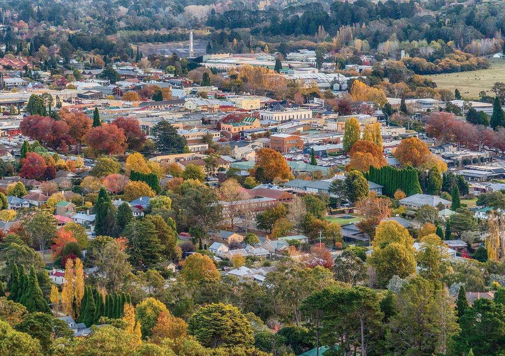 Aerial view of Bowral surrounded by colourful autumn foliage across the Southern Highlands