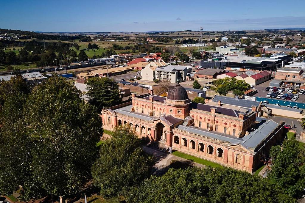 Aerial view of a heritage sandstone building in Goulburn with surrounding townscape