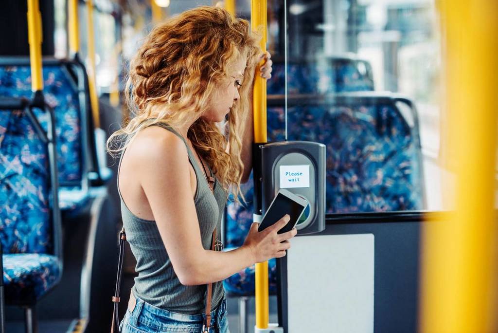 woman contactless paying for transport