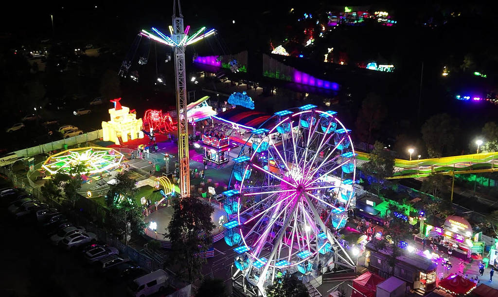 Aerial view of illuminated carnival rides and attractions at the GLOW event at Sydney Zoo