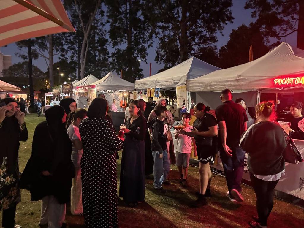 Crowds exploring food stalls at Bankstown's Eat Drink Nights night market in Western Sydney