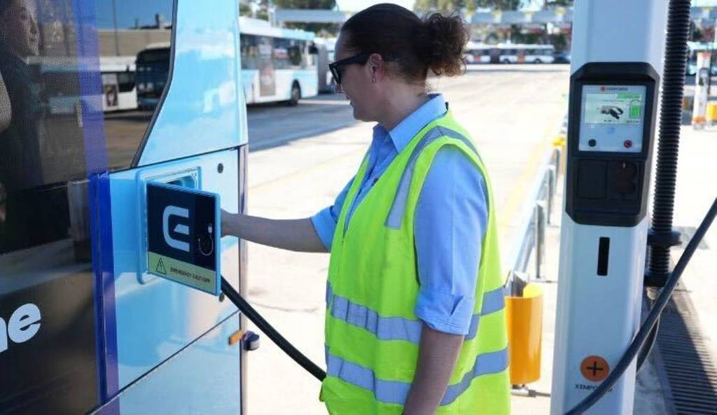 bus attendant filling up electric bus, sydney