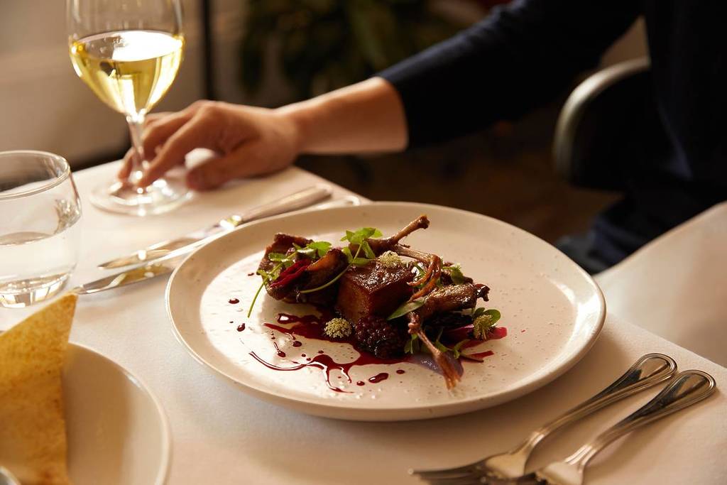 Plated modern dish with wine at a restaurant in Berrima, Southern Highlands