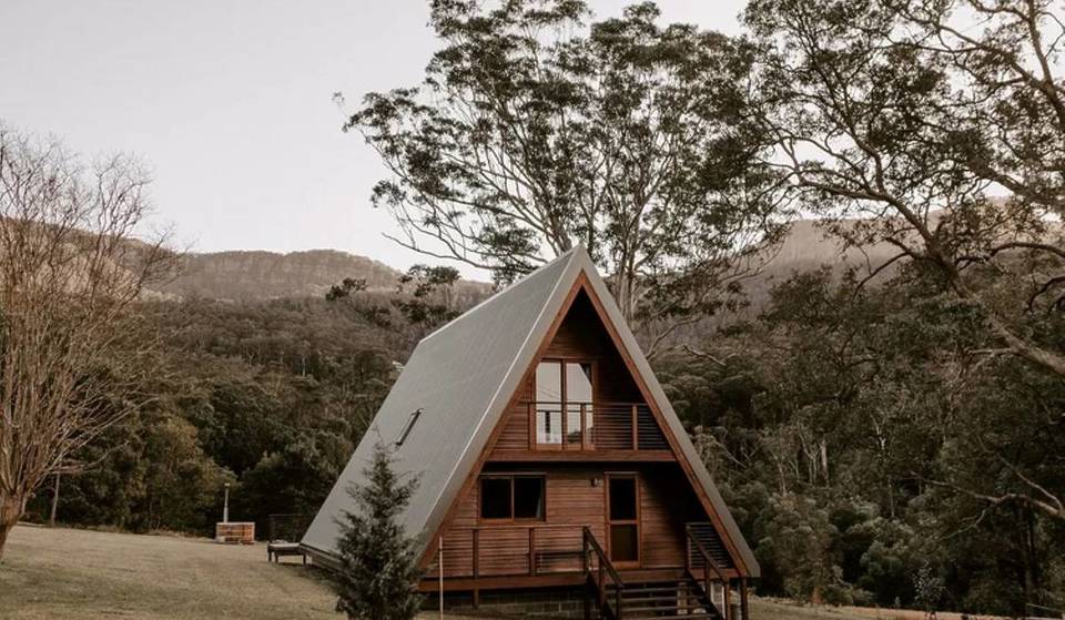 This hidden A-frame cabin with a 150-year-old terracotta roof just 2 hours from Sydney is the perfect winter escape — featuring a secret wood-fired hot tub and misty waterfalls