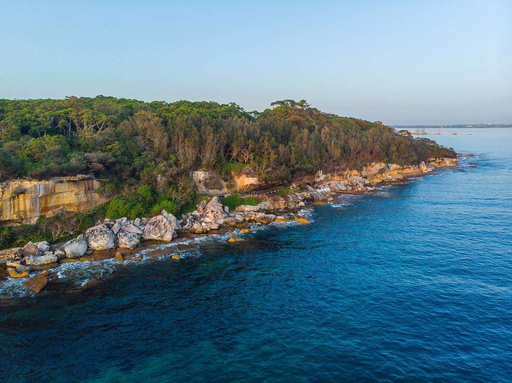 Aerial view of rugged coastline and turquoise waters in Kamay Botany Bay National Park