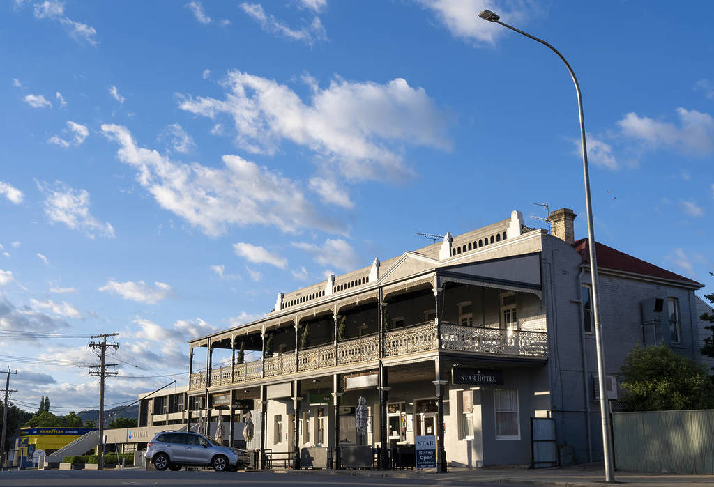 Star Hotel building in Tumut under a bright blue sky, with heritage architecture and ornate iron lacework balconies