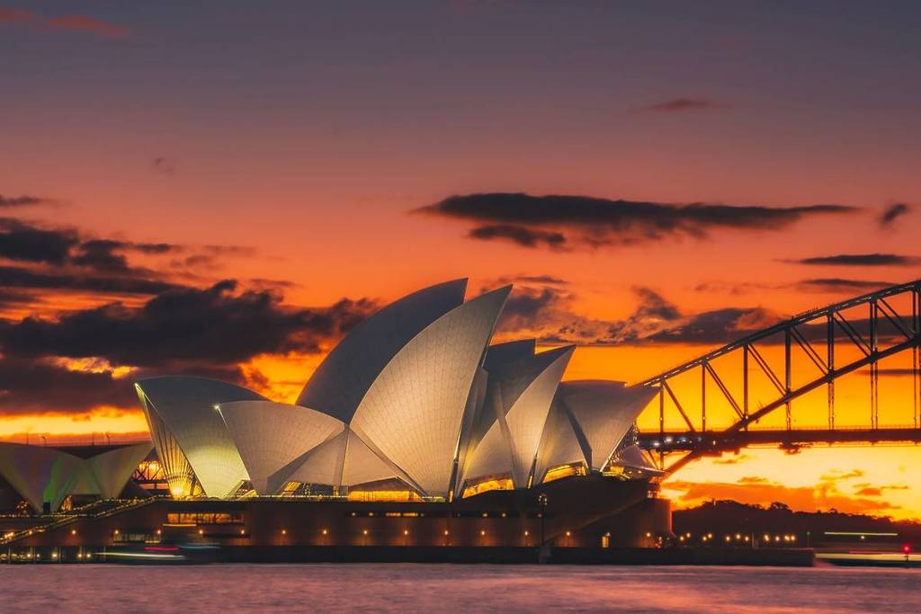 sunset at sydney opera house in circular quay, with show curfews extended till midnight