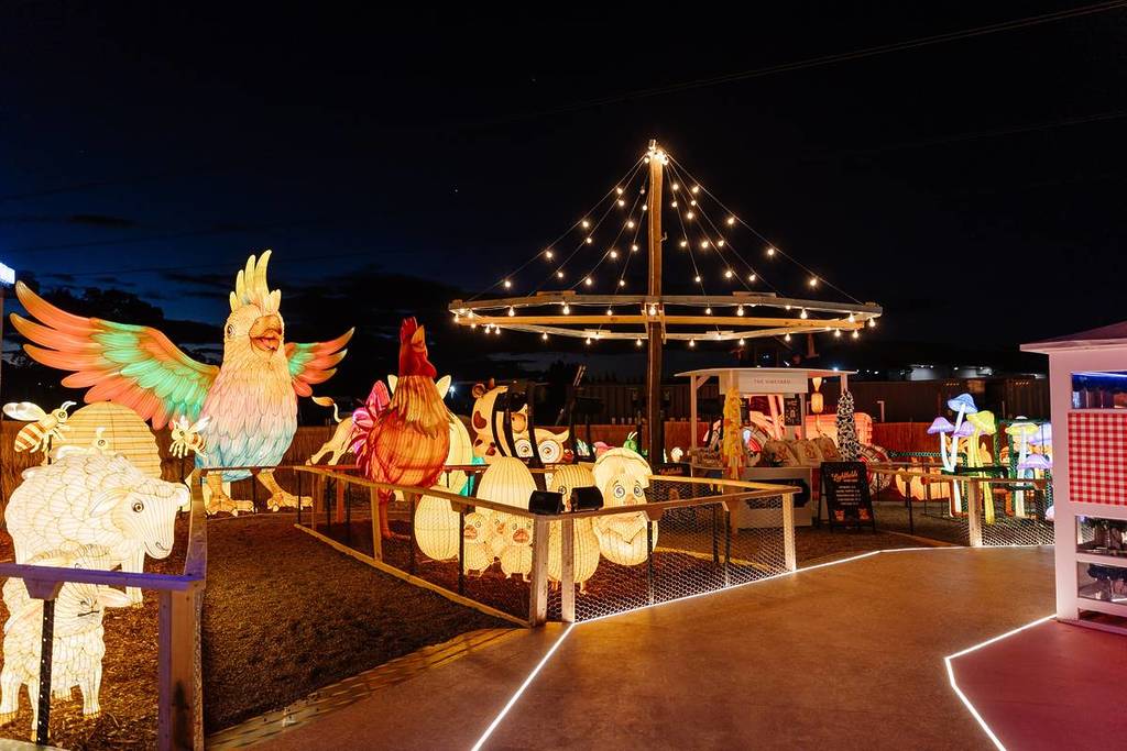 Large illuminated lantern sculptures, including a giant rainbow cockatoo and farm animals, on display at the Lightfields winter attraction