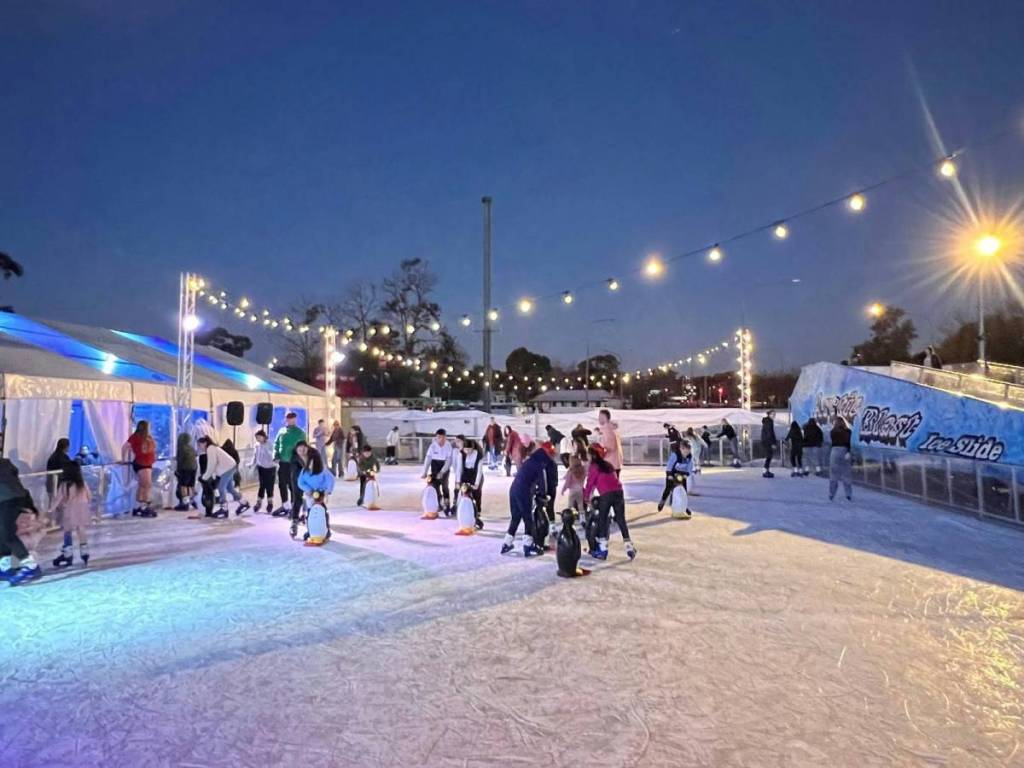 Visitors ice skating at the outdoor rink during Chill Fest in Campbelltown under festoon lights