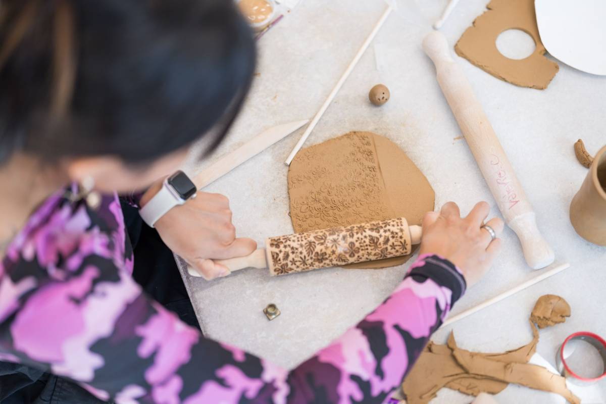 A woman works with clay at a workshop at Liverpool Powerhouse.