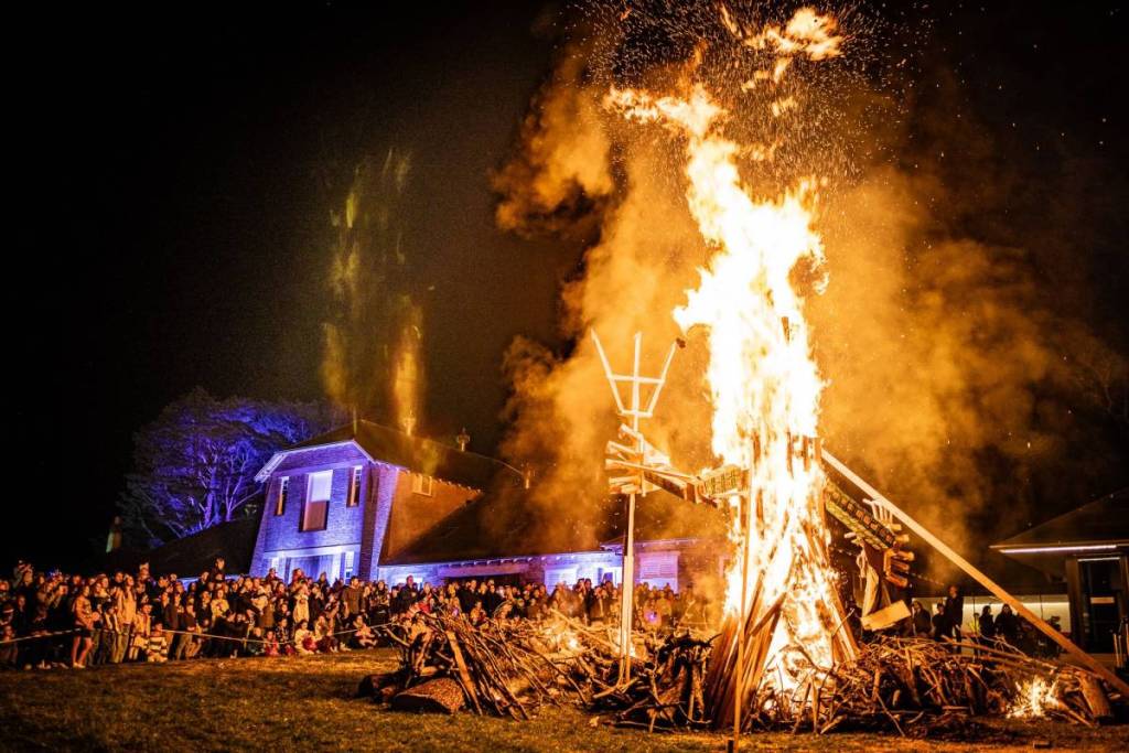 Crowds gather around the Midwinter Festival bonfire at Ngununggula in Bowral