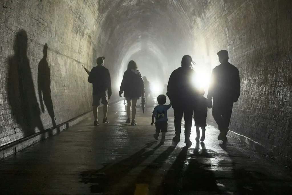 Visitors walking through the historic Lapstone Hill Tunnel in the Blue Mountains during a special public open day