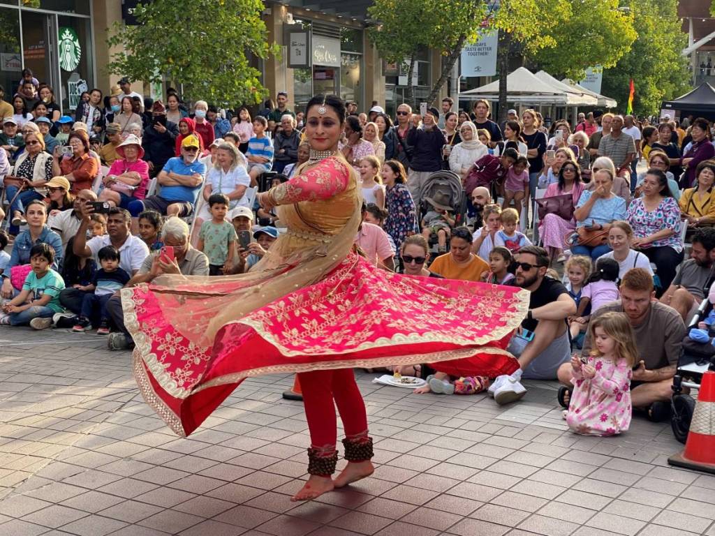 A traditional cultural dance performance at the Taste of Harmony festival in Hornsby, Sydney, with crowds watching