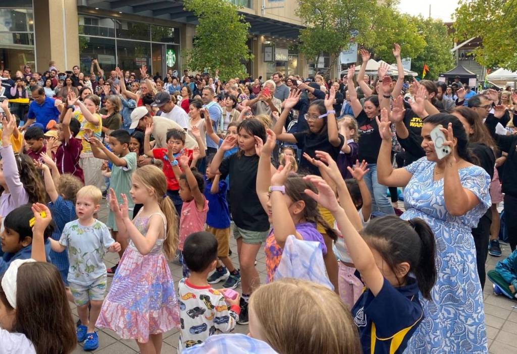Crowds enjoying live entertainment and family activities at the Taste of Harmony festival in Hornsby, Sydney