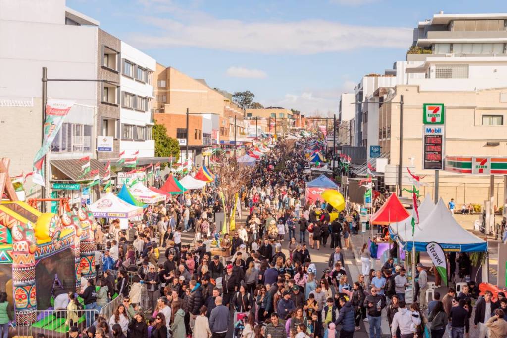 Crowds exploring food stalls and entertainment along Great North Road during the Ferragosto Italian Street Festival in Five Dock