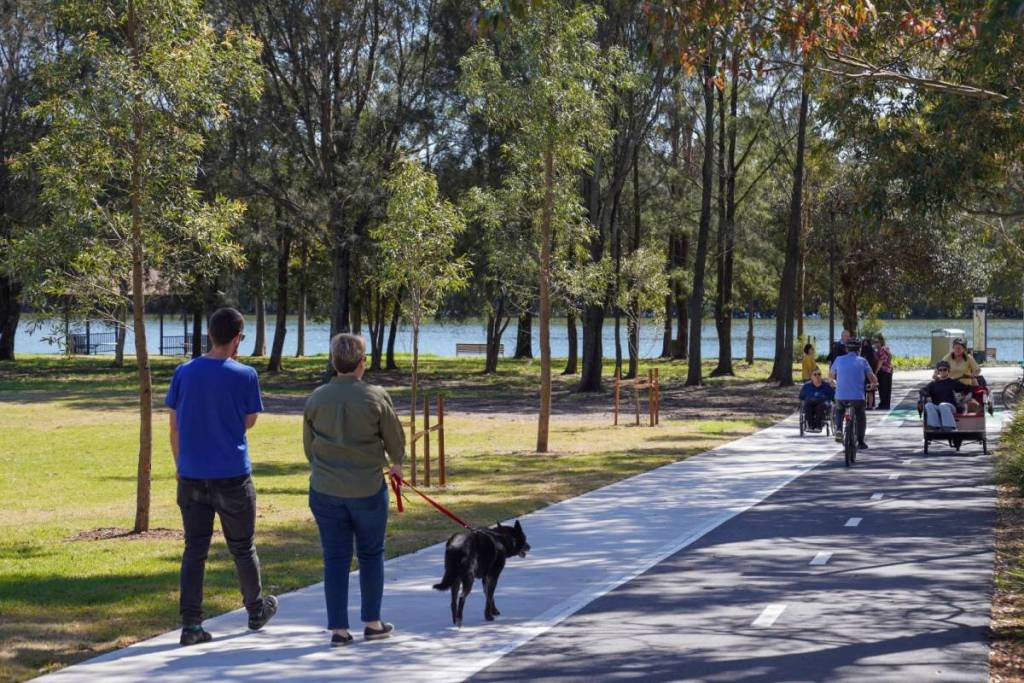 People walking and cycling along a shared path in the Duck River corridor in Western Sydney