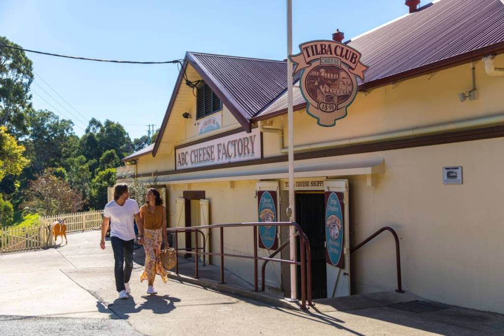 Visitors walking past the Tilba Cheese Factory in the heritage village of Central Tilba, NSW