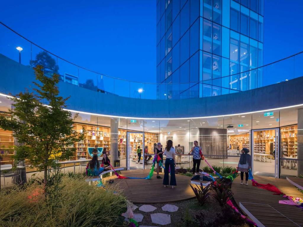 People gathered outside Green Square Library at dusk in the heart of Green Square, Sydney