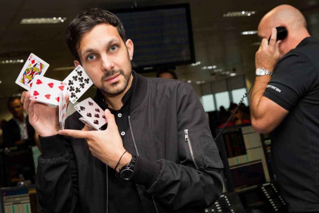 Dynamo magician shuffling cards during magic trick