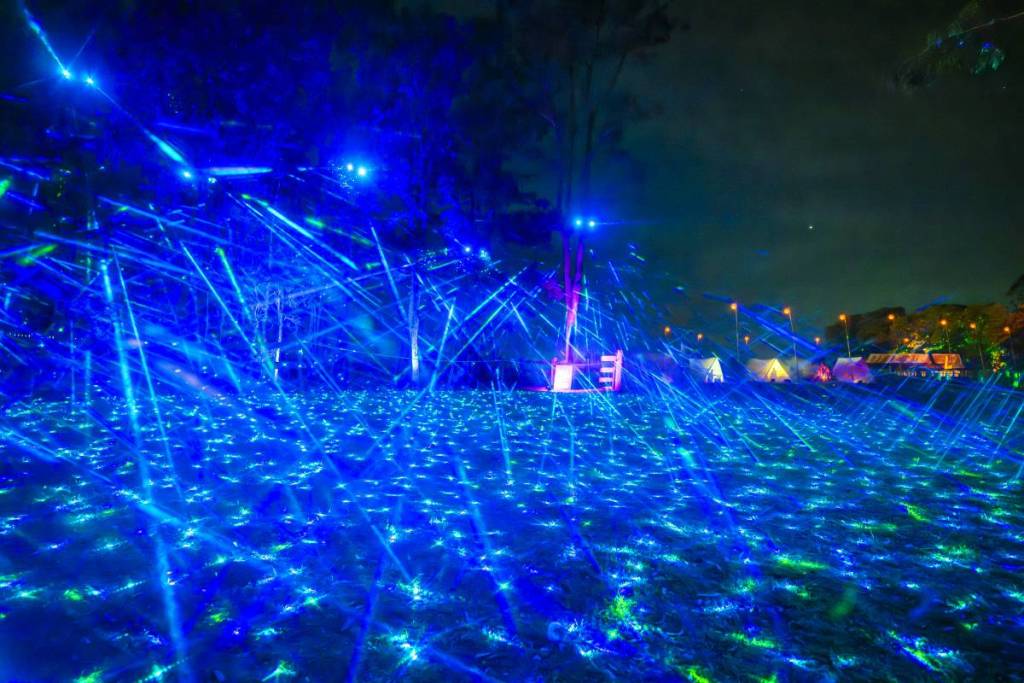Blue laser lights sweep across the grounds of Bella Vista Farm during the Echoes light show