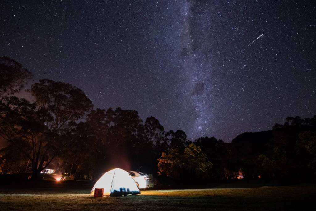 Tent beneath the Milky Way and star-filled night sky at Warrumbungle National Park