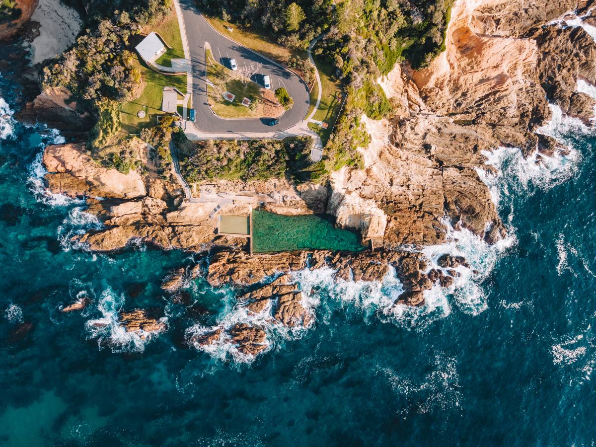 Aerial view of Bermagui Blue Pool surrounded by rocky coastline and ocean
