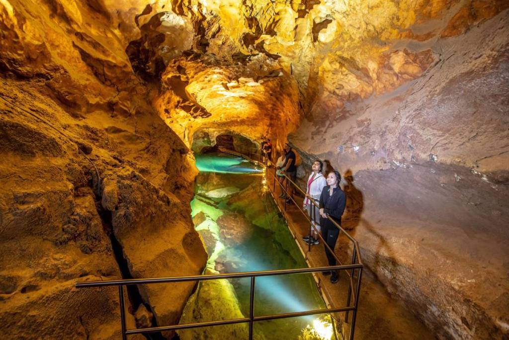 Visitors explore the illuminated limestone chambers and underground waterways of Jenolan Caves in NSW