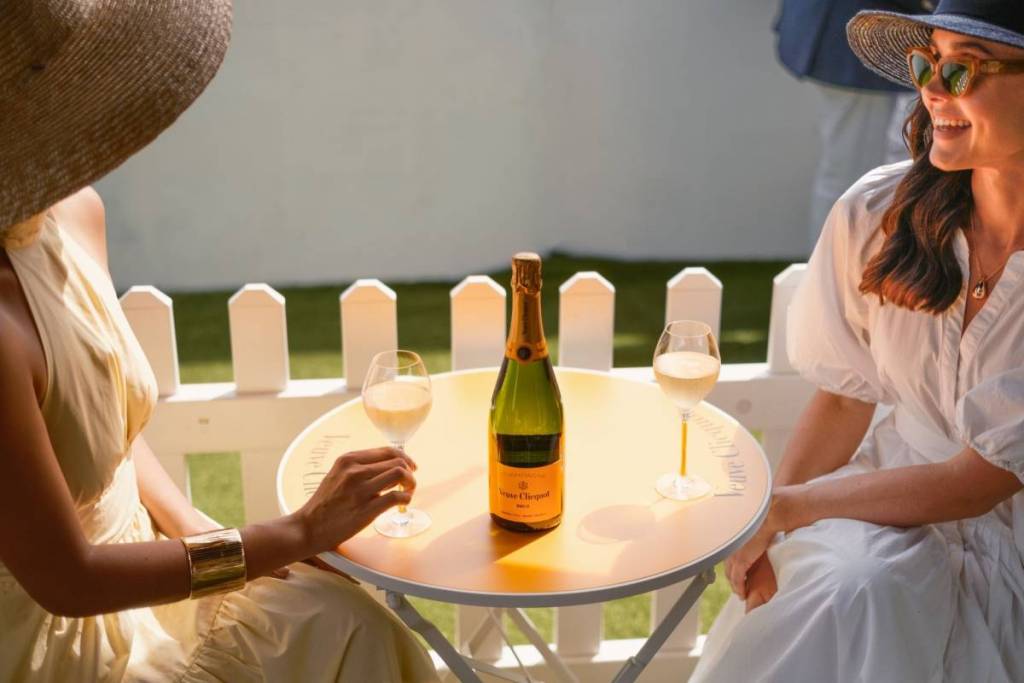 Two women share a glass of wine at F3 Polo.
