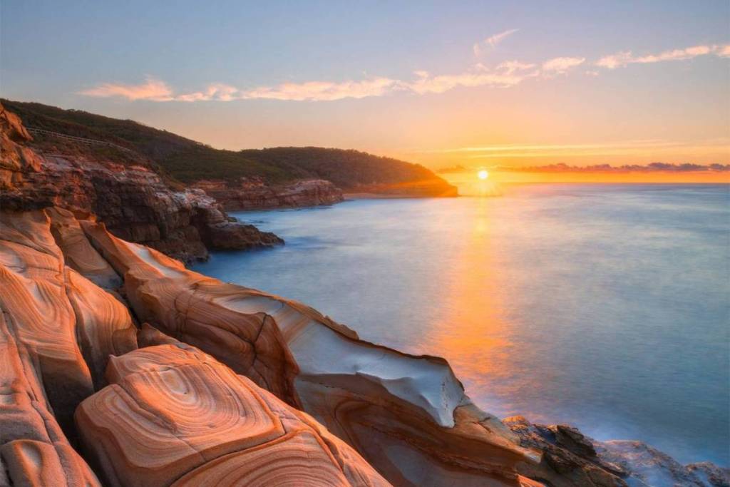 Layered sandstone cliffs overlook the ocean along the rugged coastline of Bouddi National Park