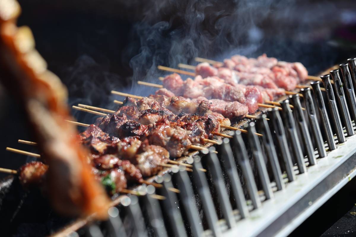 Souvlaki skewers cooking over a grill at the Love Earlwood festival