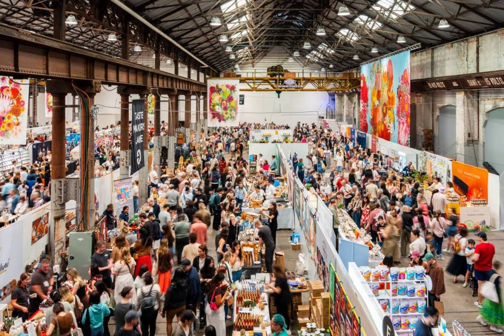 Crowds browsing rows of stalls at The Big Design Market inside Carriageworks in Sydney